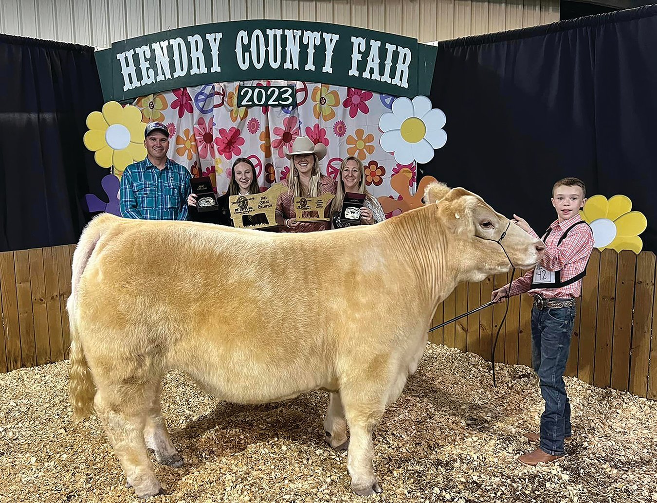 Tyler Holcomb (right) with his Grand Champion Steer